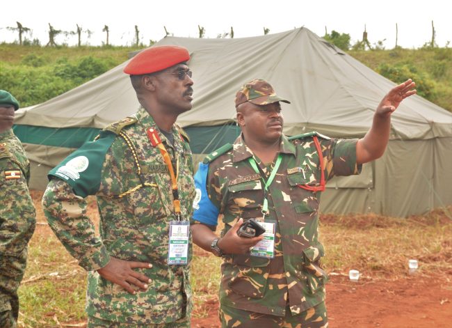 Maj Gen Don Nabasa the exercise director being oriented by Maj IC Buchuma the second in command of the Tanzanian contingent