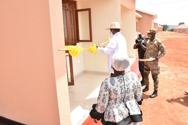 HE the President Gen Yoweri K Museveni cuts a tape while commissioning housing units constructed by SFC construction unit at Lunyo barracks on 23 July 2022