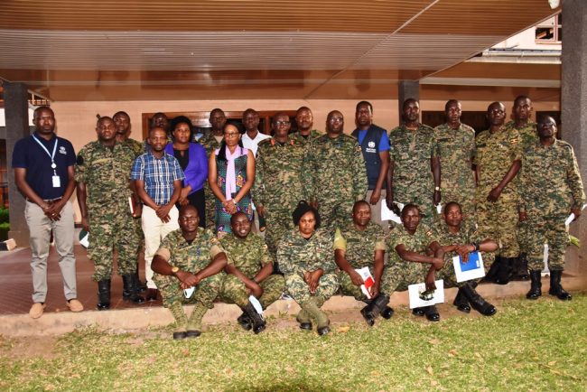 Maj Gen Dr Ambrose Musinguzi(c), Dr Anet Kisakye((l), Lt Col Xavier Bakehena(r)having a group photo with TOT Medical Workers