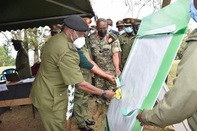CDF Gen Wilson Mbadi cuts a tape at the launch of the UPDF Biometrics system at the Ministry of Defence and Veteran Affairs in Mbuya