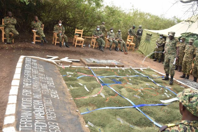 Capt Arthur Nabasa demonstrating combat engineer tactics to the Chief of Defence forces (CDF) Gen Wilson Mbasu Mbadi while in kalama for the passout of Engineers officers basic course