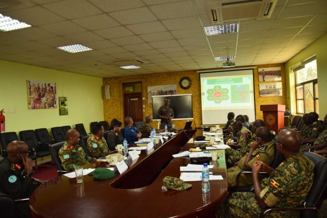 Attendees of the meeting listening to a presentation by Lt Col Otiso_transcpr