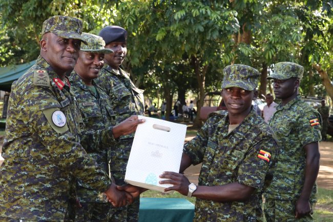 Brig Gen Michael Nyarwa Awarding a prize to the best student Pte Tumuhimbise Aaron