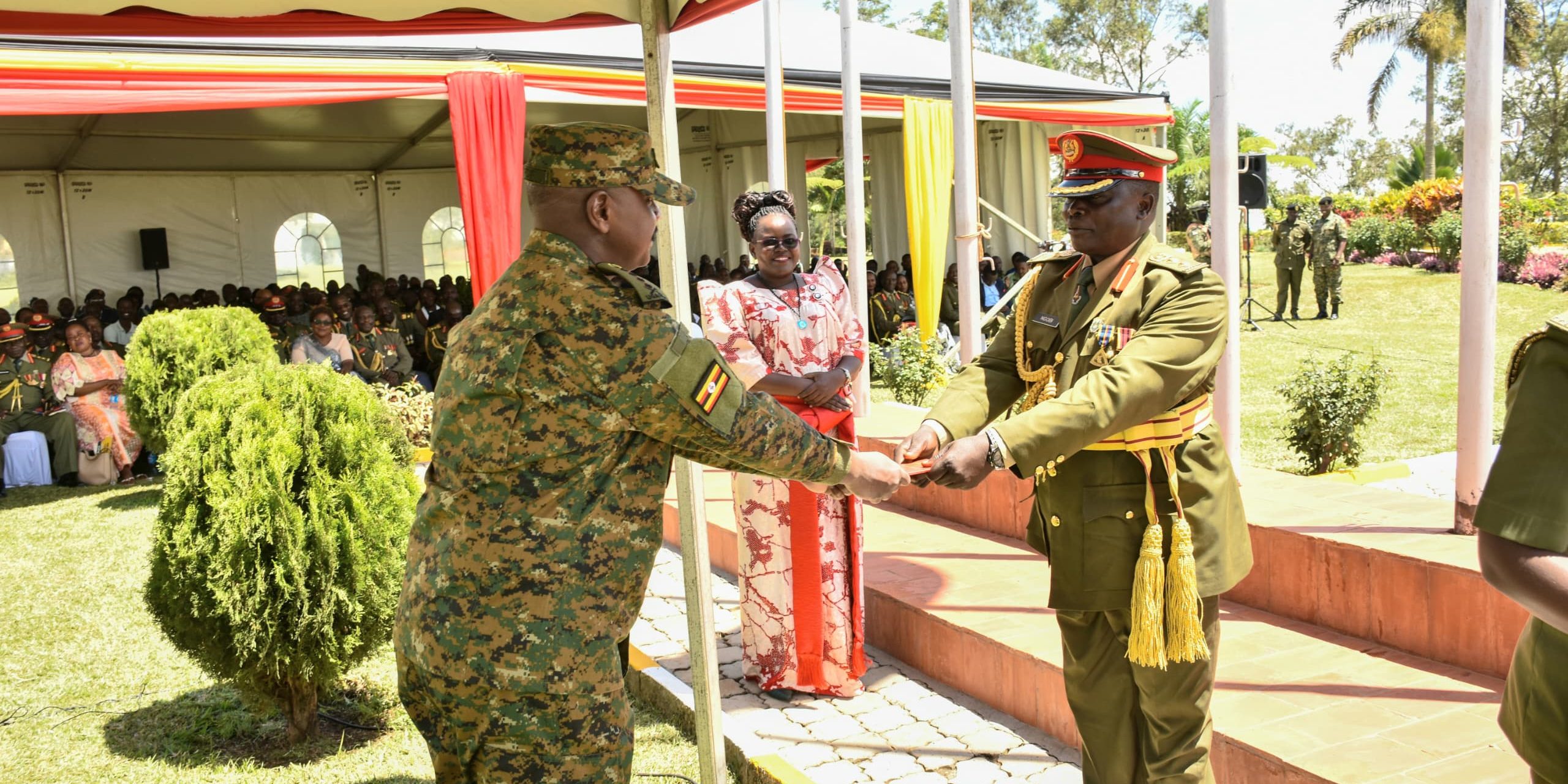 CDF Gen Muhoozi Kainerugaba giving discharge certificate to Rtd Col Sam Ngobi at the retirement ceremony of senior officers at MoDVA Hqrs