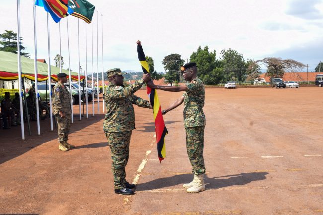 Chief of Staff land Force Brig Gen Micheal Kabango recieving back th eflag fron EAC 13th Ushirikiano contigent
