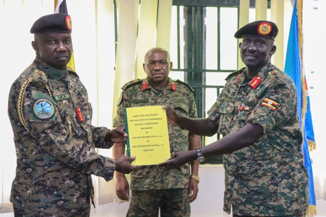 Maj Gen Richard Otto(R) handingover a report to Maj Gen Dick Olum(L)