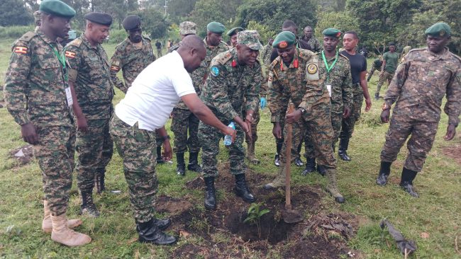 Col Col. Paul Muwonge the twice Mtn Div comdr with Col Talemwa the Director Education and Sports Land forces plant tress at the banks of River Mpanga in Fortpartal City
