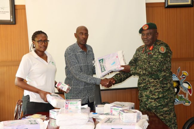 Bri Gen Micheal Kibuye reciving might pain relif patach and pads from Rtd Brid Gen Emmanuel Rwashande at MODVA Hq