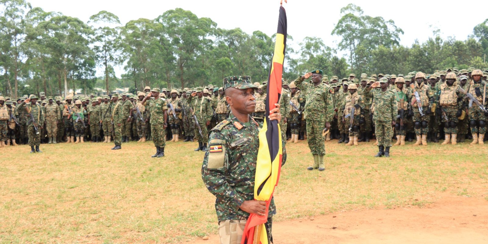 Col Musenene Holding the Uganda Flag