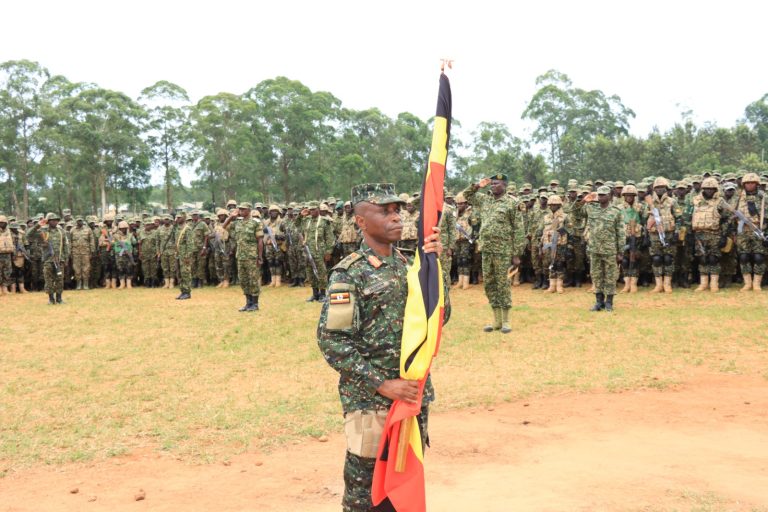 Col Musenene Holding the Uganda Flag