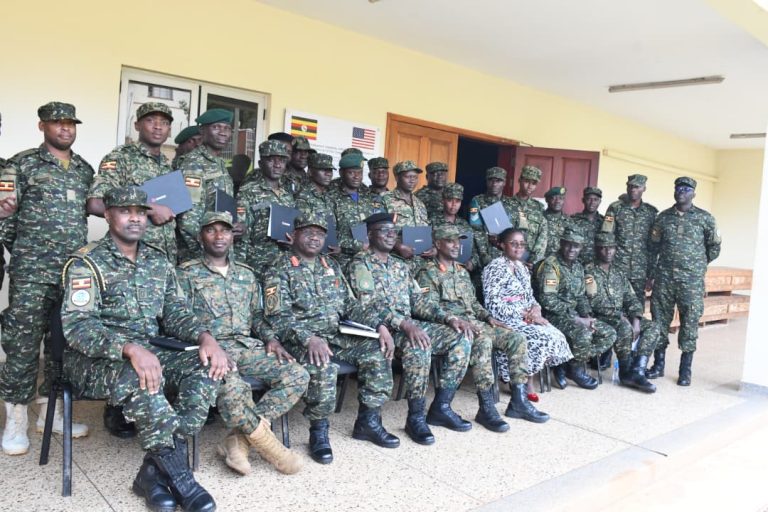 Chief guest posses for a group photo with graduands.JPG