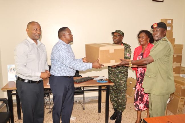 Col Dr Francis Bakehena (C) Receiving the gene expert machine..JPG