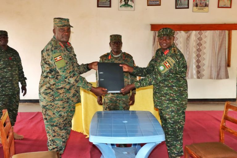 3DOTO (Caretaker deputy commander) right side hand over file to incoming deputy commander Col Mugarura