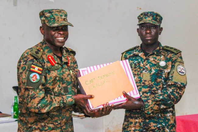 Col Mwebaza giving the gift and certificate to the best student