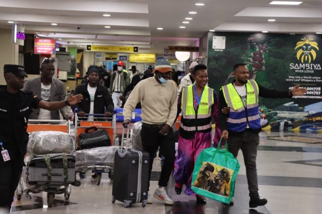 Some of the 256 nationals making their way to arrival lounge at Entebbe International Airport..jpg