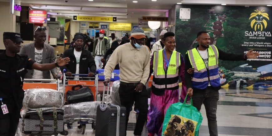 Some of the 256 nationals making their way to arrival lounge at Entebbe International Airport..jpg