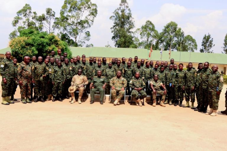 Chief Guest Brig Gen R. Wakayinja (C) seated row with Graduants.jpg