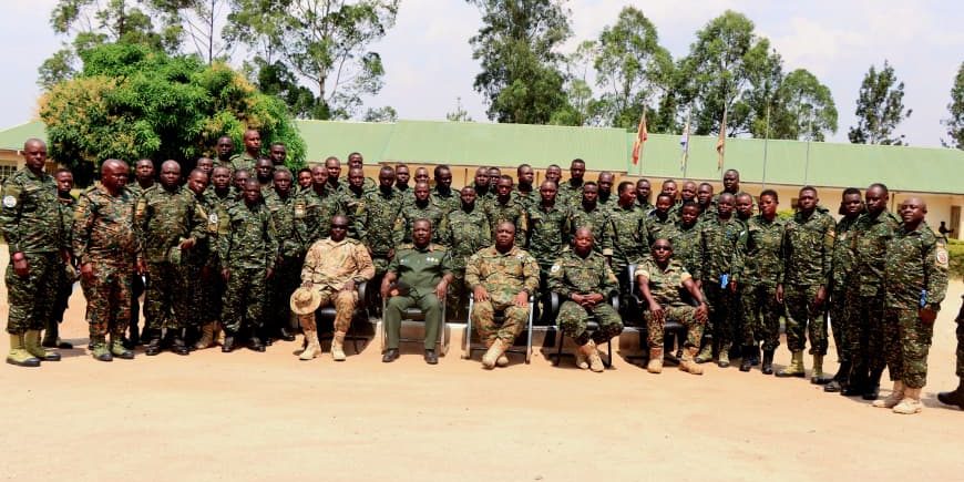 Chief Guest Brig Gen R. Wakayinja (C) seated row with Graduants.jpg
