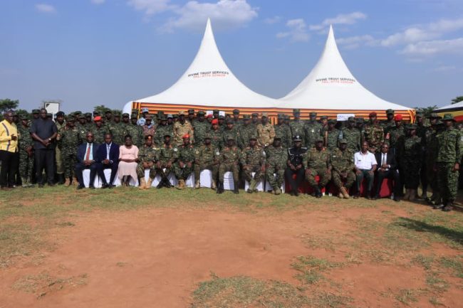 Graduands, invited guests in photo with chief guest Maj Gen Don Nabasa (C).JPG