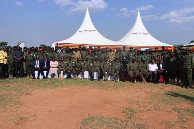 Graduands, invited guests in photo with chief guest Maj Gen Don Nabasa (C).JPG