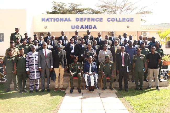 Members of Parliament on Defence and Internal Affairs Committe in a group photo with the Commandant and Directing staff of National Defence College Uganda..JPG