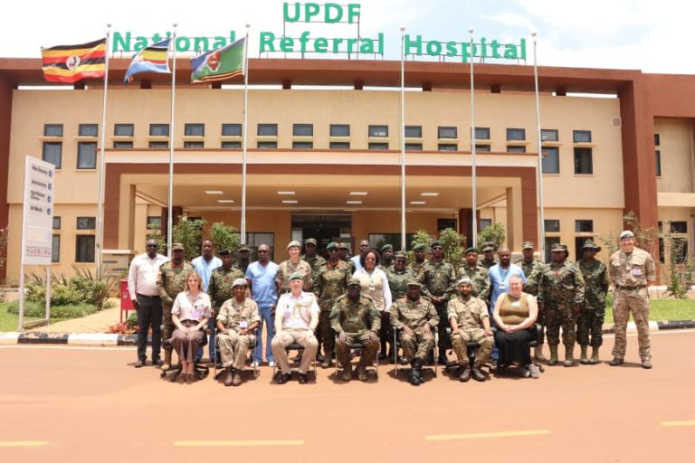 Brig Gen Dr Patrick Ochen, UPDF NRH Leadership sharing a group photo with UK Deligation.JPG